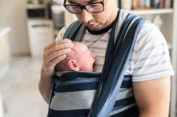 his daughter close in a baby carrier