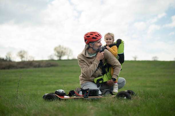 Father carries his daughter in a baby carrier