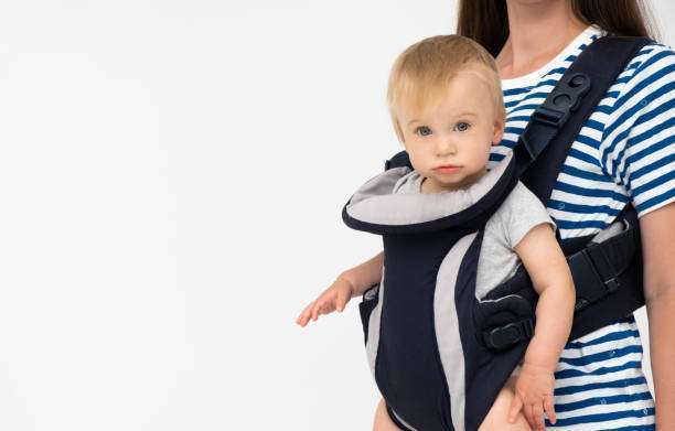 child looking at camera in structured baby carrier