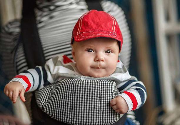 baby sitting in an ergonomic baby carrier