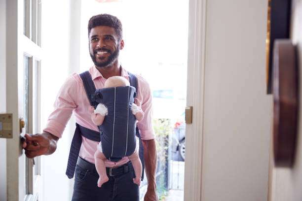 The baby fell asleep in the baby carrier.