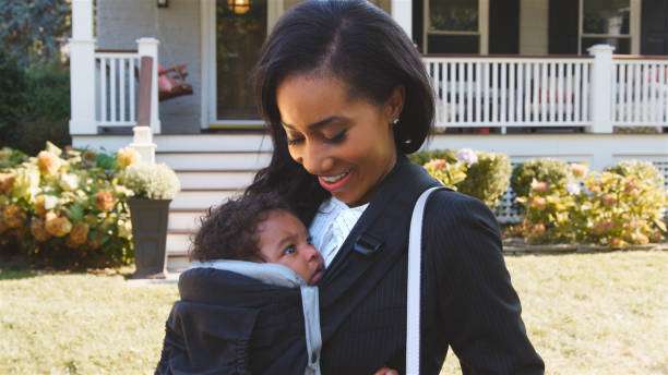 Photo of a woman with her baby in a baby carrier