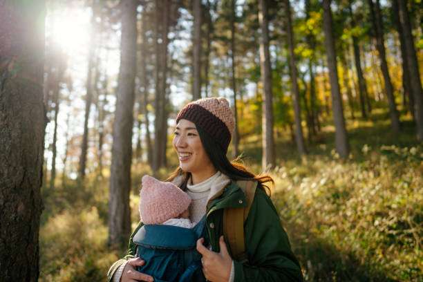 Photo of a Japanese woman with her baby in a baby carrier