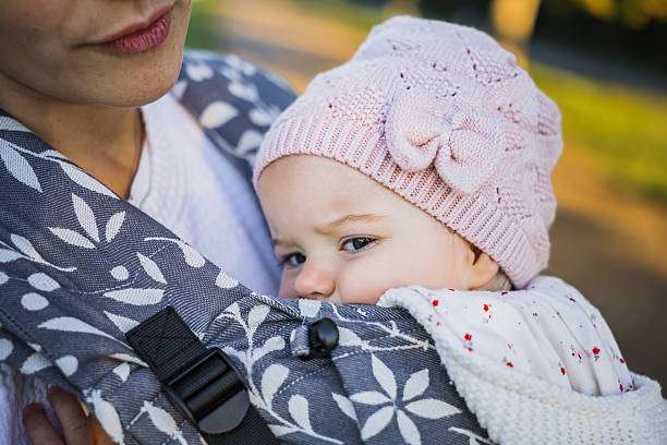 her daughter in baby carrier during a walk.