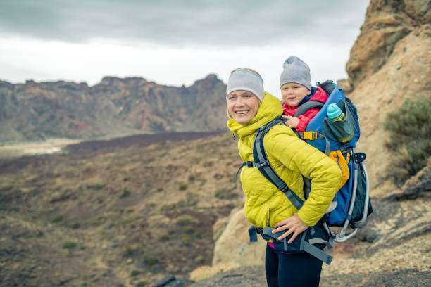 Vacation journey with an infant baby carrier on back, weekend travel in Tenerife, Spain.